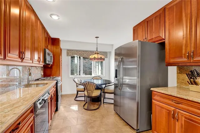 a kitchen with a sink refrigerator and cabinets