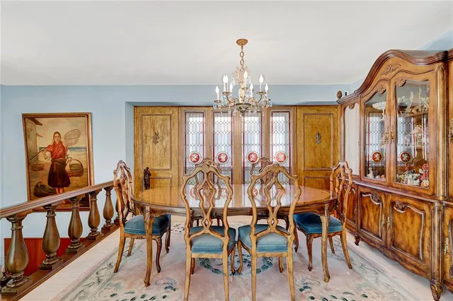 a view of a dining room with furniture and chandelier