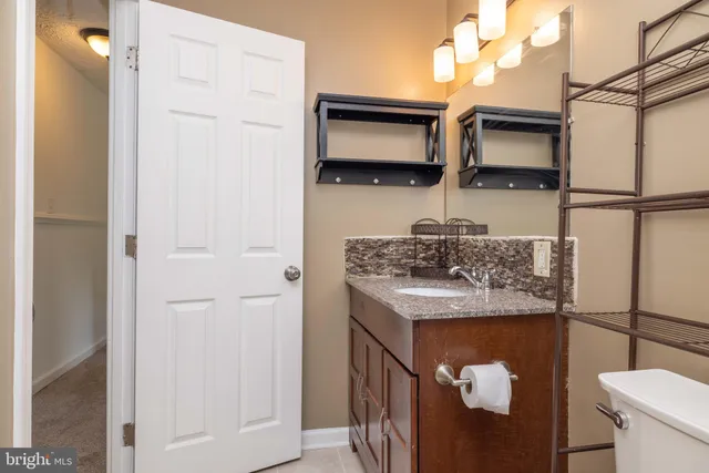 a kitchen with stainless steel appliances granite countertop a sink a stove and wooden floor