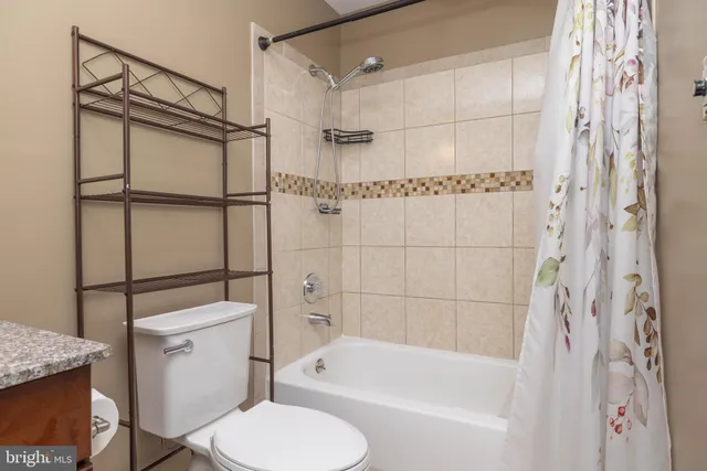 a hallway with wooden floor fireplace and windows