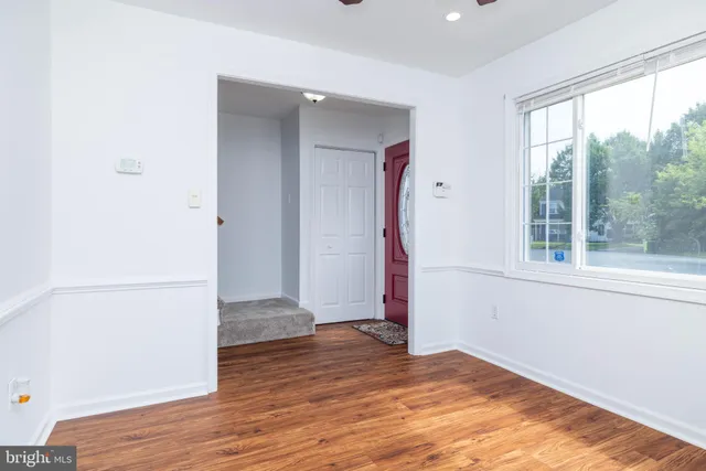 a view of a room with wooden floor