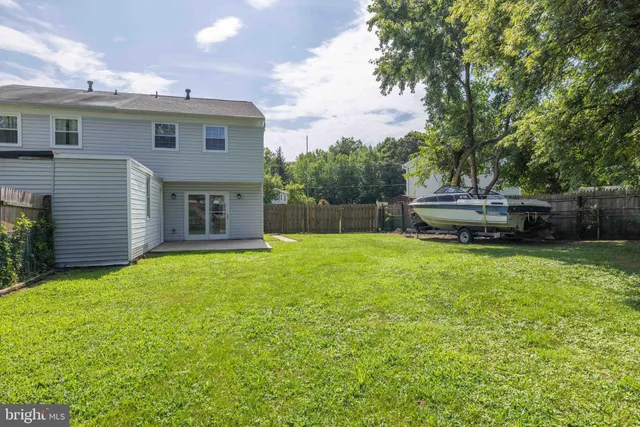 a view of a backyard with large trees