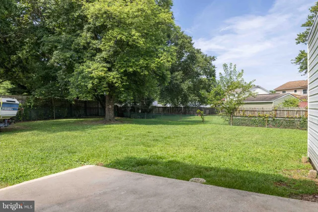 a white toilet sitting next to a white wall