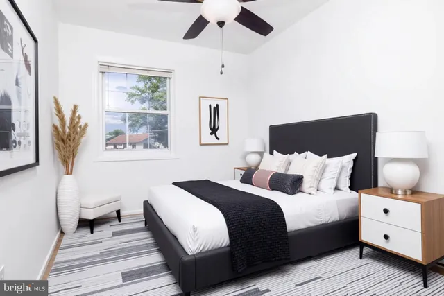 a bathroom with a granite countertop sink toilet a mirror and shower
