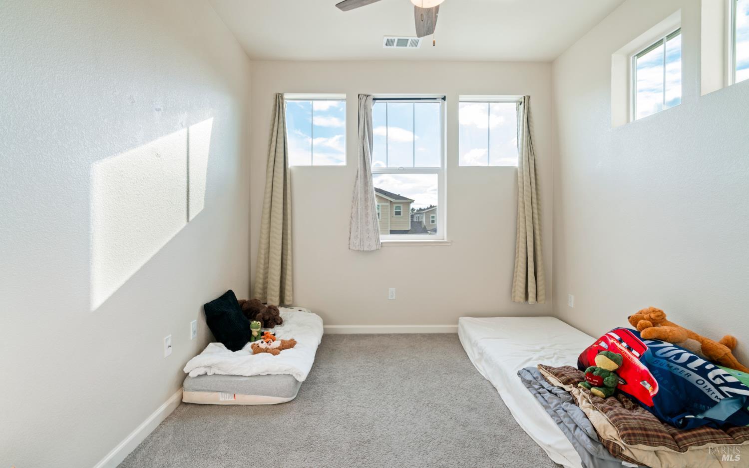 1461 Cecilia Drive Santa Rosa, CA 95401 - Photo 13 of 20 a bedroom with a bed and a window