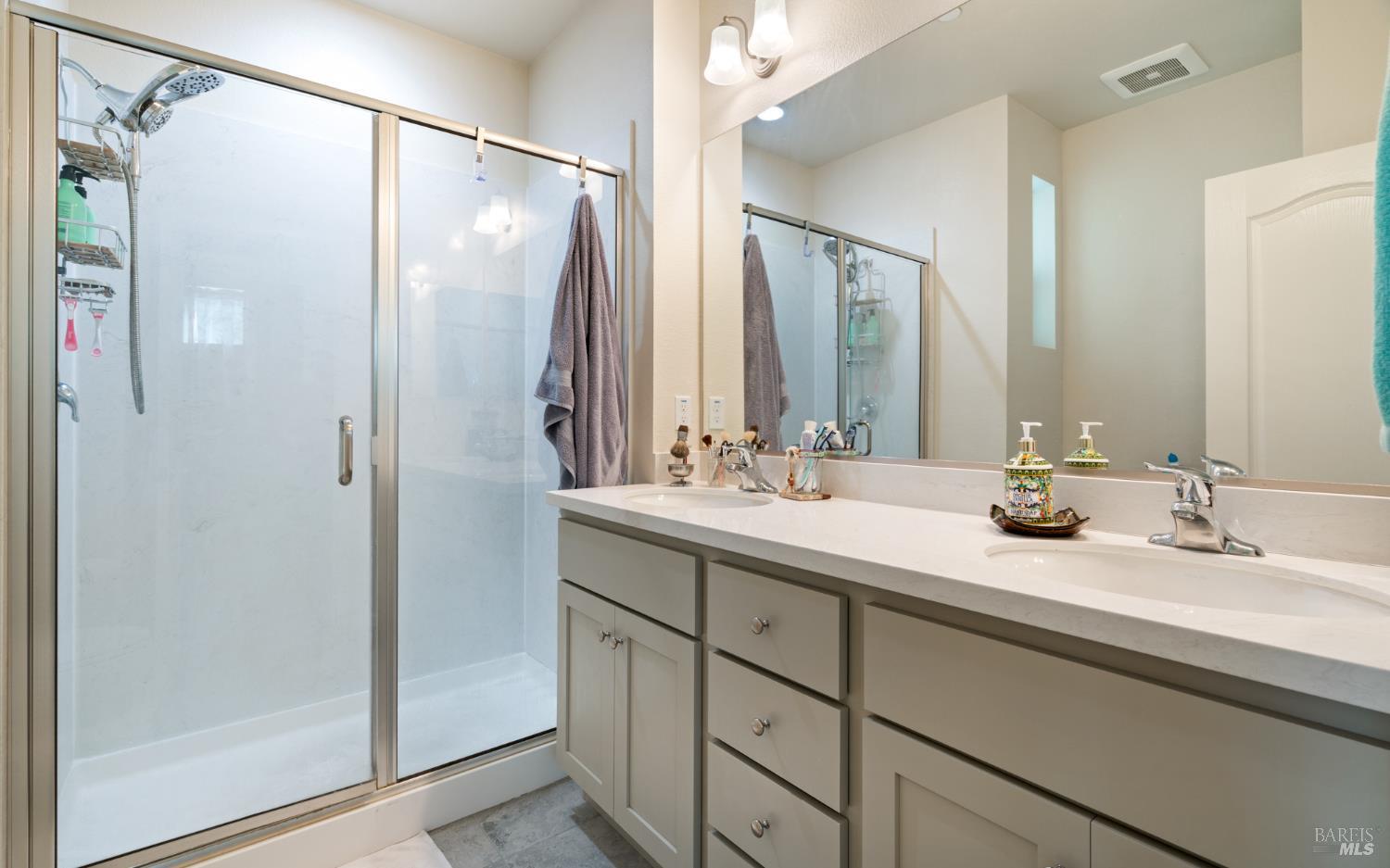 1461 Cecilia Drive Santa Rosa, CA 95401 - Photo 17 of 20 a bathroom with a double vanity sink mirror and shower