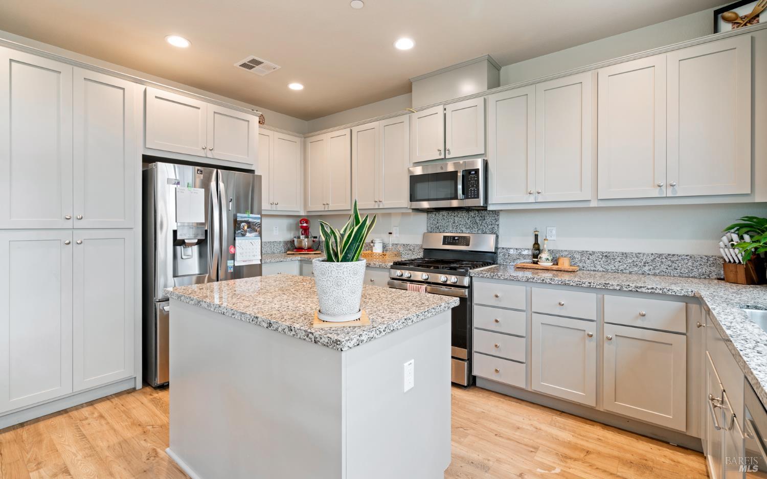 1461 Cecilia Drive Santa Rosa, CA 95401 - Photo 3 of 20 a kitchen with stainless steel appliances granite countertop a refrigerator sink and stove