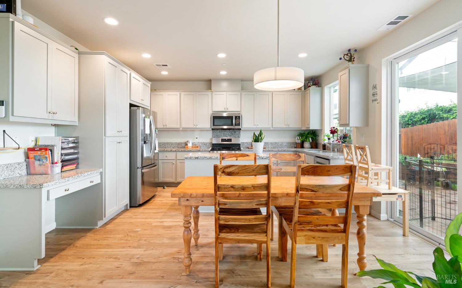 1461 Cecilia Drive Santa Rosa, CA 95401 - Photo 6 of 20 a kitchen with stainless steel appliances kitchen island granite countertop a refrigerator and microwave