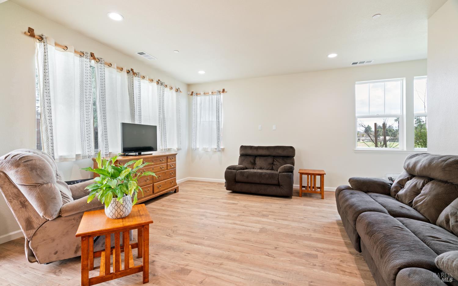 1461 Cecilia Drive Santa Rosa, CA 95401 - Photo 8 of 20 a living room with furniture a flat screen tv and a window