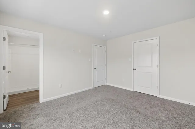 a bathroom with a granite countertop sink a toilet and shower