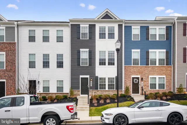 a front view of a house with parking space