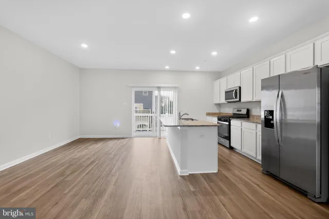 a kitchen with a refrigerator and a sink