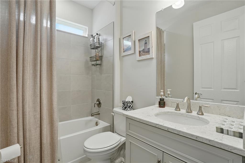 28165 Captiva Shell Loop Bonita Springs, FL 34135 - Photo 22 of 38 a bathroom with a granite countertop sink a toilet and shower