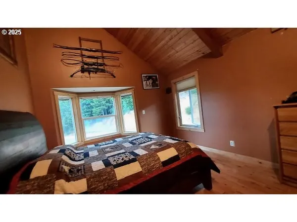 a living room with a bed furniture and a window