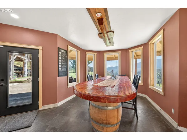 a open kitchen with stainless steel appliances kitchen island granite countertop a refrigerator a stove a sink dishwasher and a dining table with the kitchen view