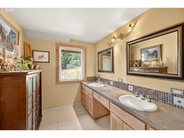 a bathroom with a granite countertop sink a mirror and a shower