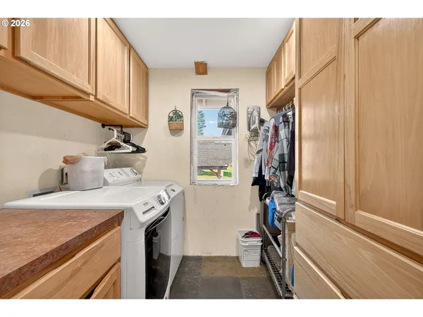 a bathroom with a granite countertop toilet sink and mirror