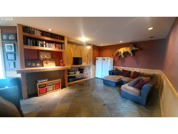 a living room with furniture and a book shelf