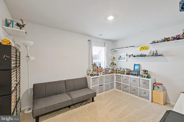 a kitchen with a stove a refrigerator and a dining table with wooden floor