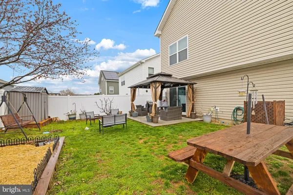 a view of a house with backyard and sitting area