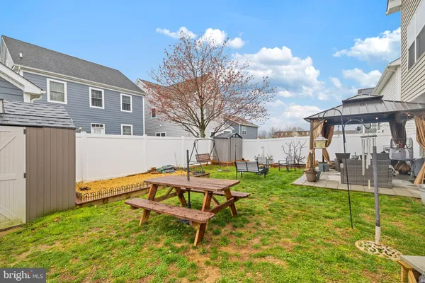 a swimming pool with outdoor seating and yard