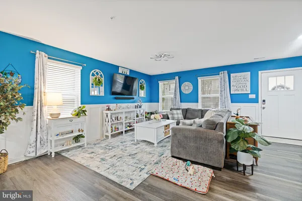 a living room with furniture and wooden floor