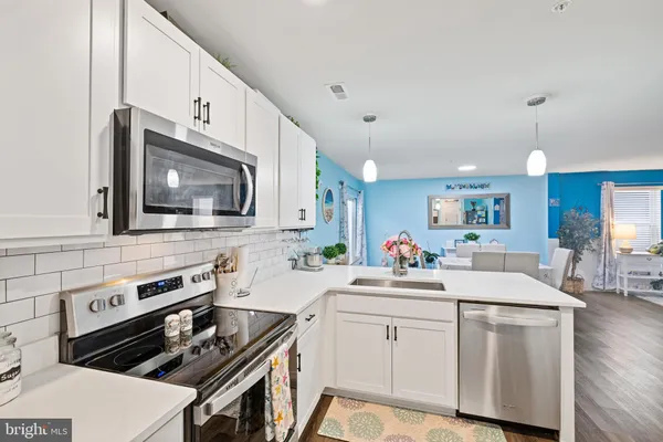 a kitchen that has a sink and a stove top oven