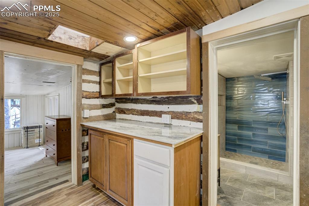 4560 Canonwood Road Colorado Springs, CO 80906 - Photo 17 of 50 a bathroom with a granite countertop sink and a mirror