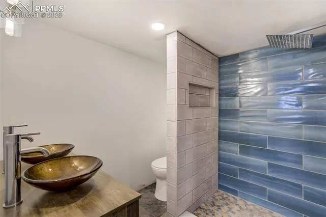 a bathroom with a toilet and a shower