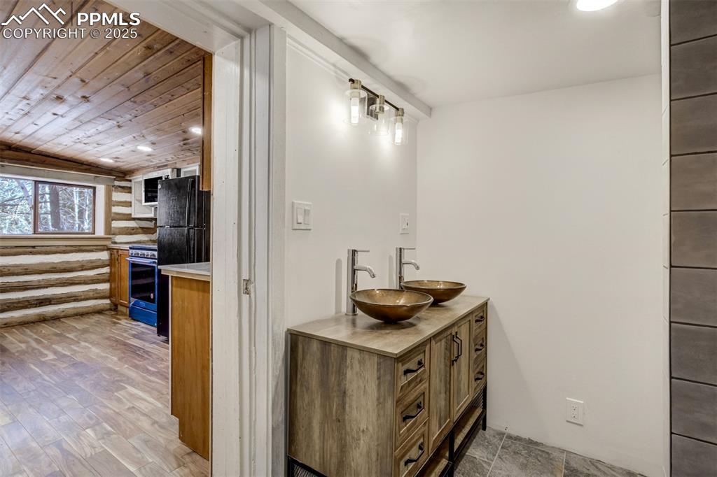 4560 Canonwood Road Colorado Springs, CO 80906 - Photo 21 of 50 a bathroom with a sink and a mirror