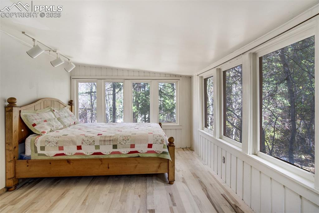 4560 Canonwood Road Colorado Springs, CO 80906 - Photo 23 of 50 a large bed sitting in a bedroom next to a large window