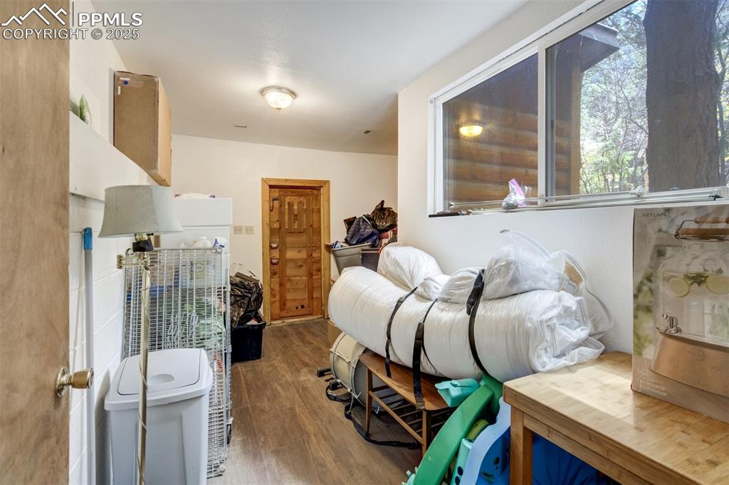 4560 Canonwood Road Colorado Springs, CO 80906 - Photo 29 of 50 a bedroom with furniture and a wooden floor