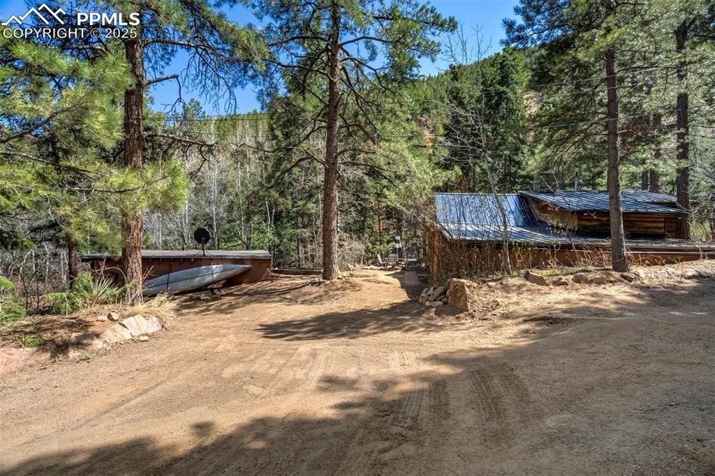 4560 Canonwood Road Colorado Springs, CO 80906 - Photo 36 of 50 a view of backyard with wooden fence and a large tree