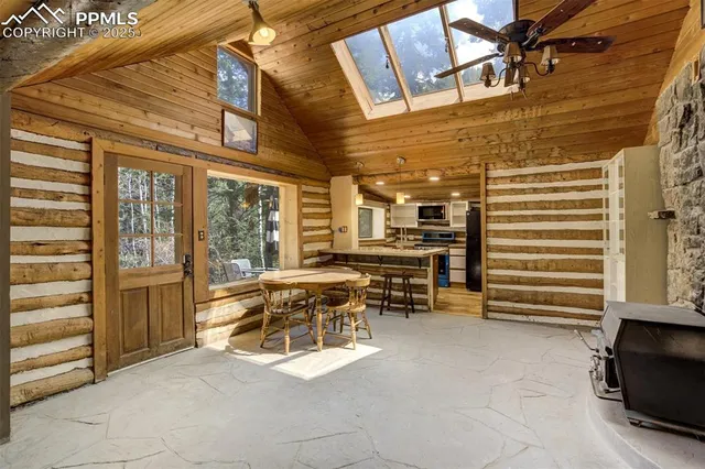 a view of a patio with table and chairs and a barbeque