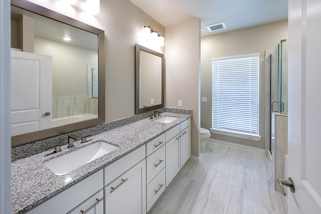 1724 Partnership Way, Unit 3101 Katy, TX 77449 - Photo 25 of 30 a bathroom with a granite countertop double vanity sink and a mirror