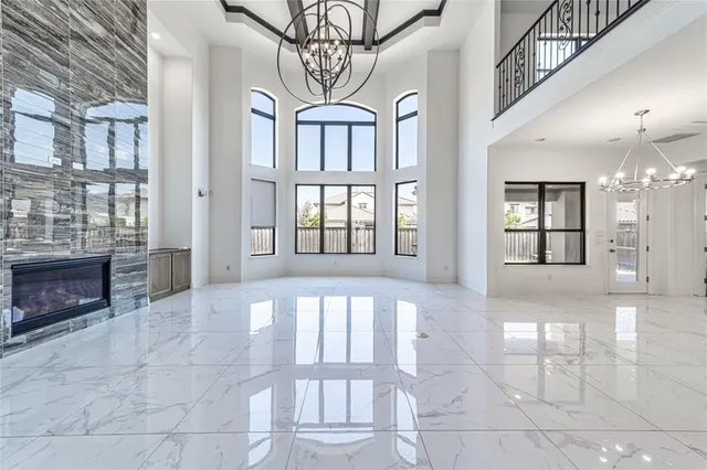 a large kitchen with granite countertop a large counter top and stainless steel appliances