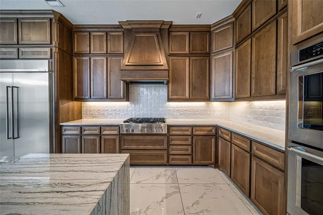 a bathroom with a bathtub a double vanity sink shower and mirror