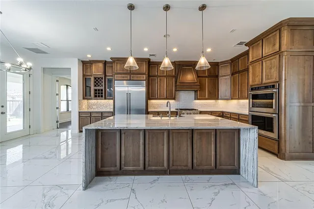 a view of a big room with chandelier fan and windows
