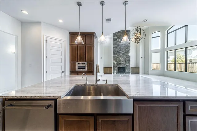 a kitchen with a stove sink and cabinets