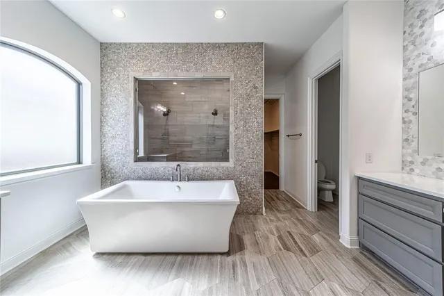 wooden floor in an empty room with a chandelier