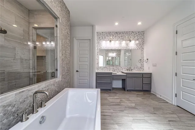 a bathroom with a toilet sink vanity and mirror