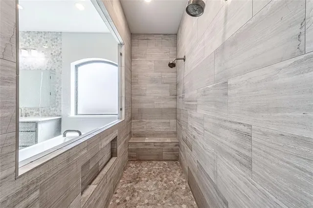 a bathroom with a bathtub and a shower