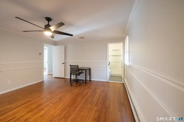 a view of a livingroom with a hardwood floor and a ceiling fan