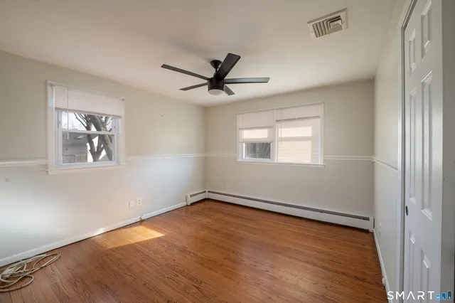 wooden floor in an empty room with a window