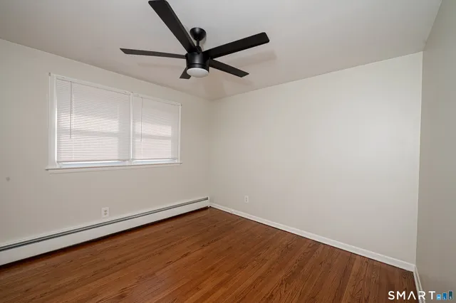 a view of a room with wooden floor and windows