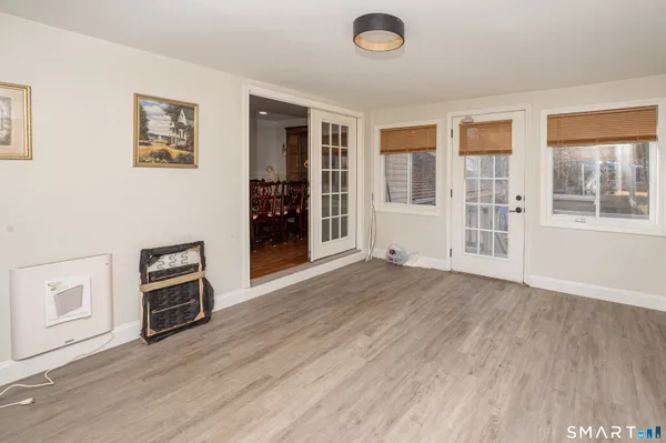 a kitchen with stainless steel appliances granite countertop a refrigerator a sink dishwasher a stove and white countertops with wooden floor