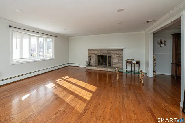 a living room with hard wood floors and a table