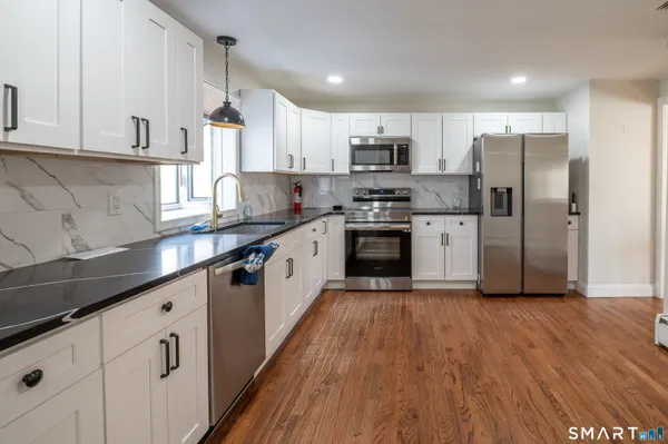 a living room with hard wood floors and a table
