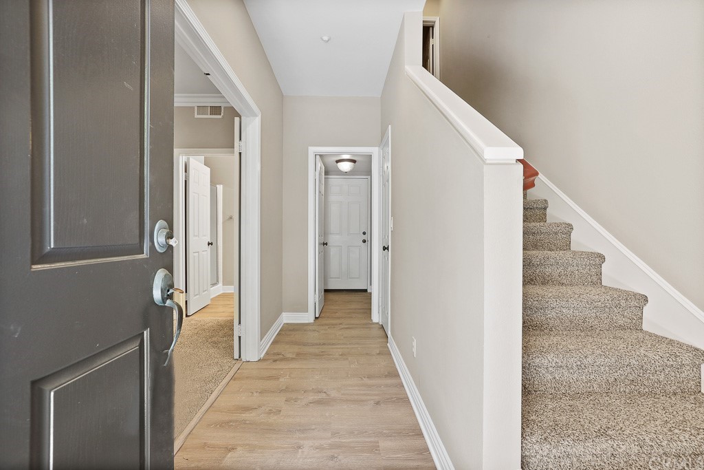 6 Paseo Del Rey San Clemente, CA 92673 - Photo 1 of 1 a view of a hallway with wooden floor and staircase
