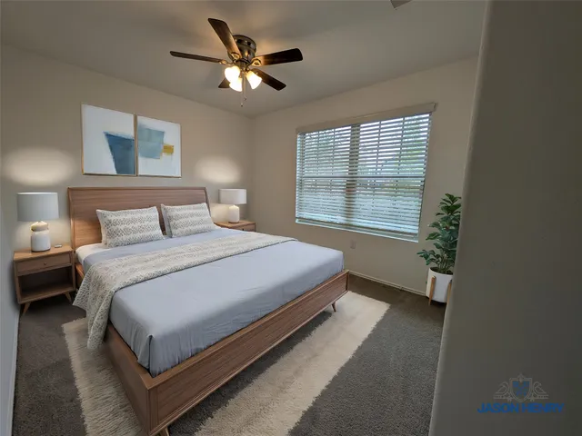 a bedroom with a large bed and a window